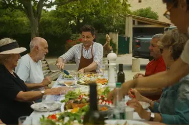 Hugo geniet samen met de lokale bevolking van het eten dat zij hebben gemaakt.