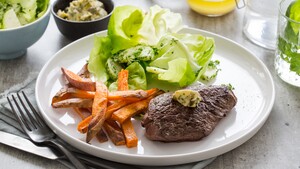 Steak frites met simpele beurre Café de Paris, zoete-aardappelfrietjes en tuinkruidensalade