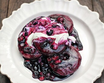 Ontbijtdonuts met honing, blauwe bessen en yoghurt
