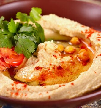 Hummus met tomaten en basilicum