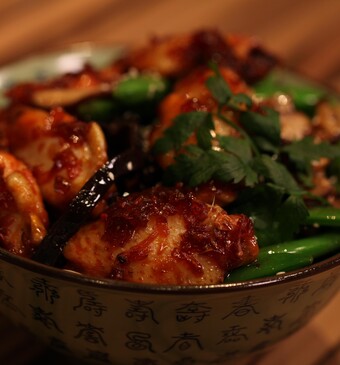 Gekaramelliseerde kippenvleugeltjes met paddenstoelen uit de wok