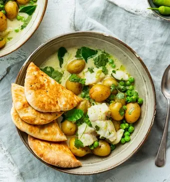 Curry met zeewolf, krieltjes en doperwten