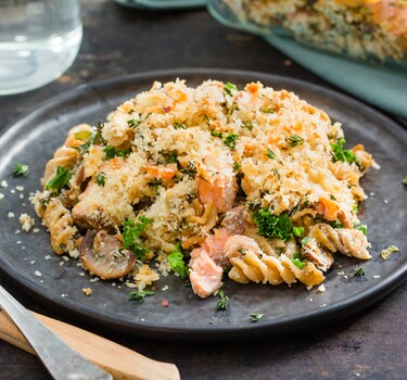 Romige boerenkoolpasta uit de oven met zalm, champignons en citroen